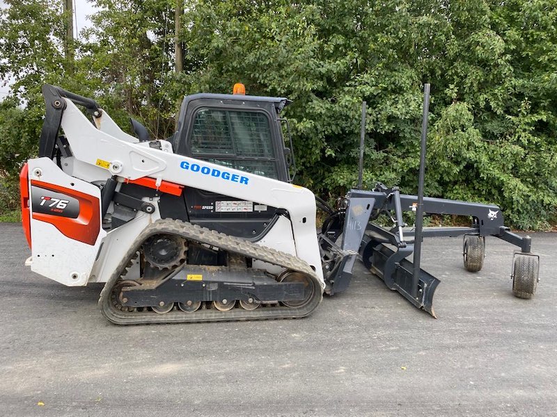 Side view of T76 Bobcat with 84” grader attachment and 2D laser level setup